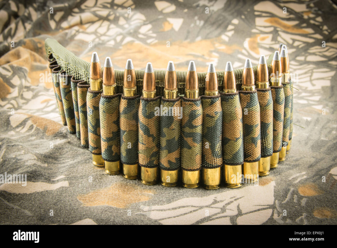 camouflage ammunition belt for rifle on camouflage background Stock Photo