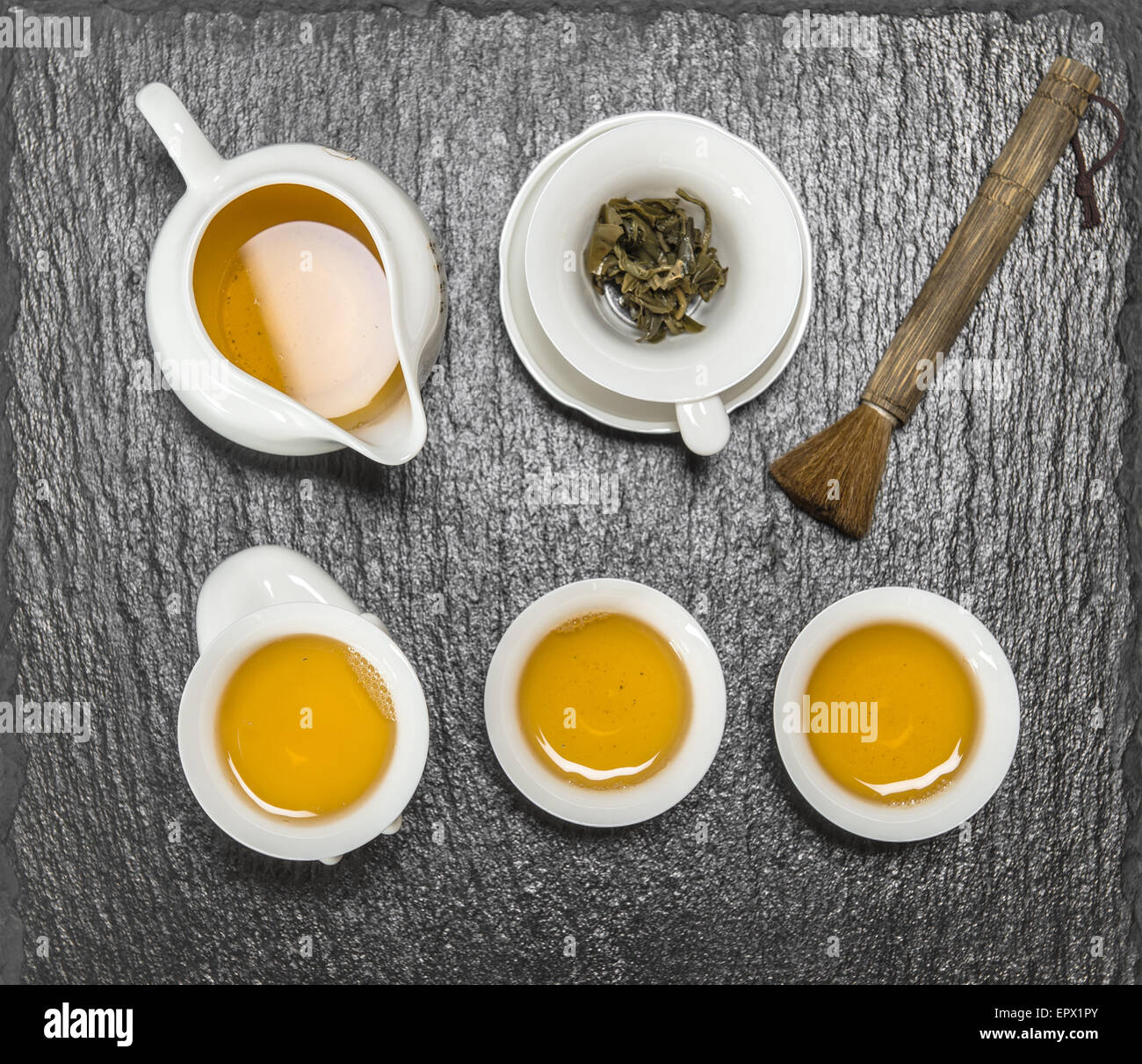 Teapot and white cups on stone table. Utensils for traditional chinese tea ceremony Stock Photo