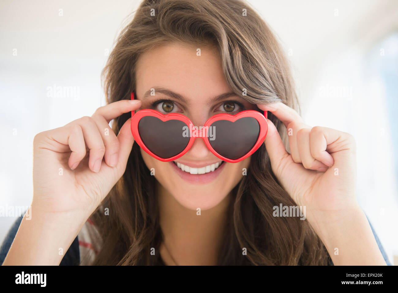 Portrait of woman in heartshaped sunglasses Stock Photo
