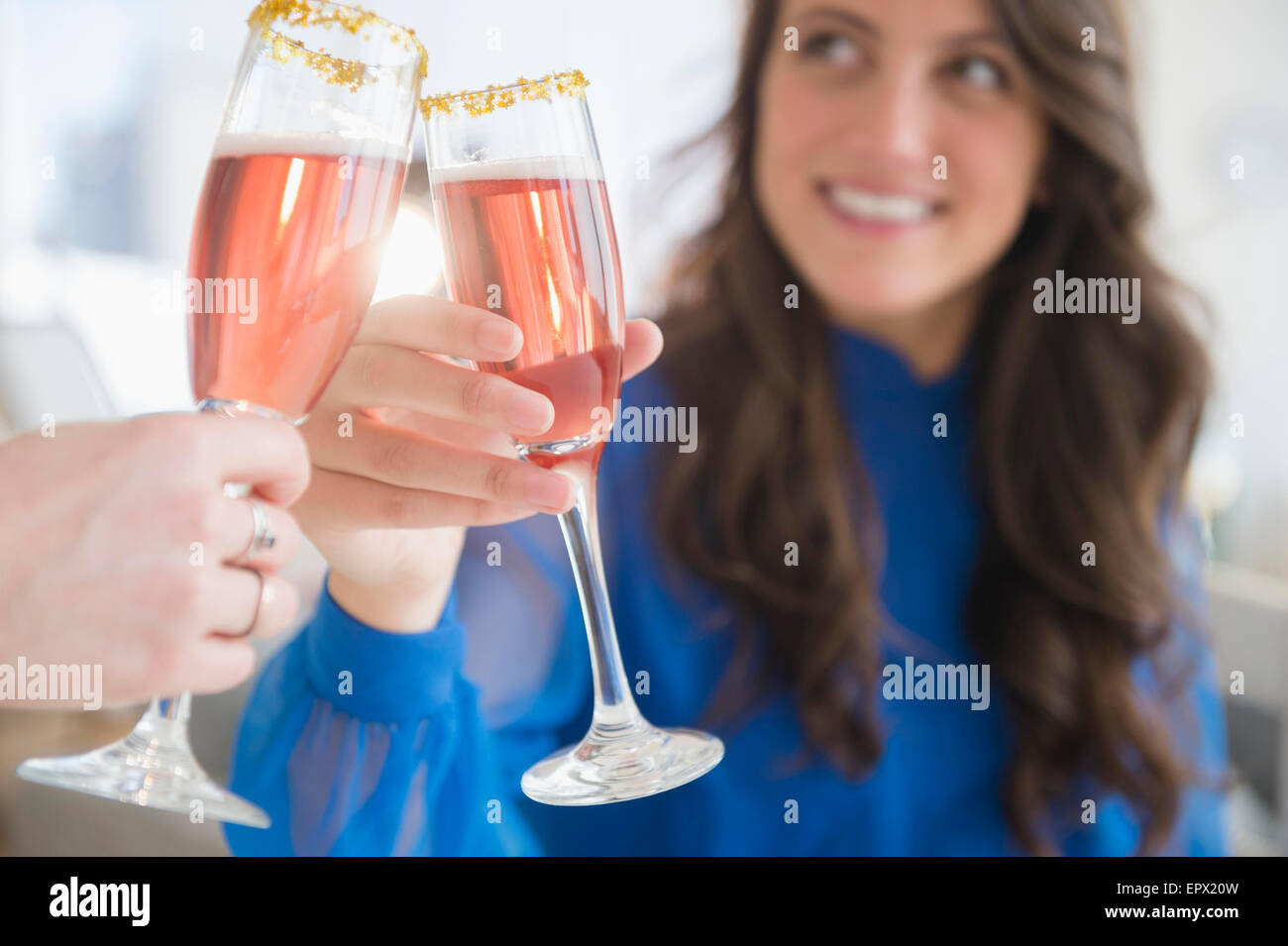 Woman making a toast with another Stock Photo Alamy