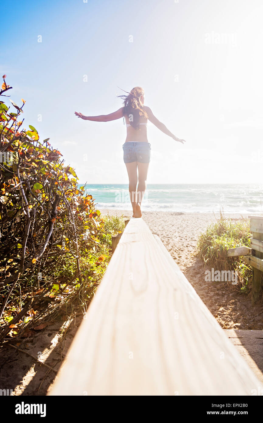 USA, Florida, Jupiter, Young woman balancing on boardwalk Stock Photo