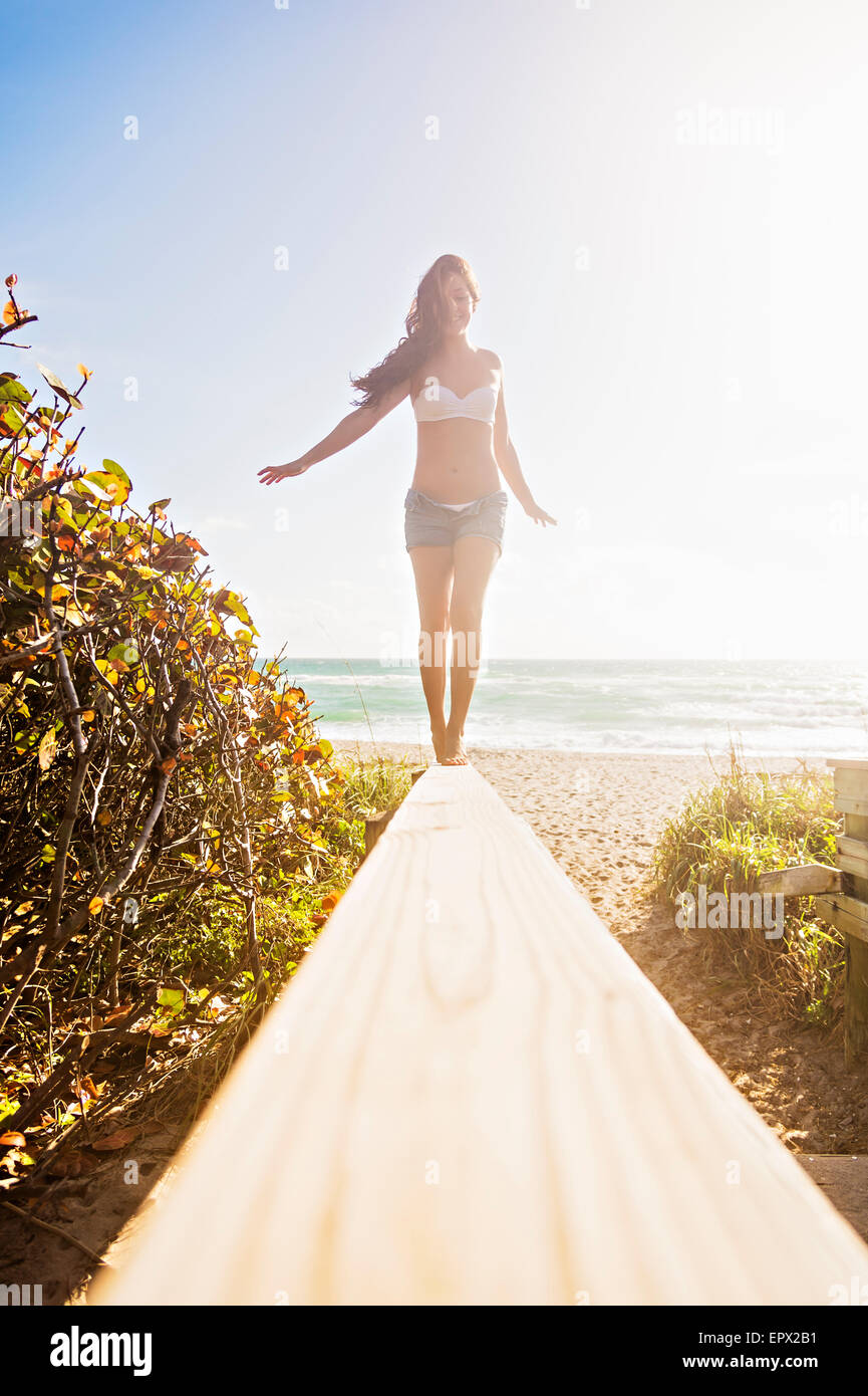 USA, Florida, Jupiter, Young woman balancing on boardwalk Stock Photo