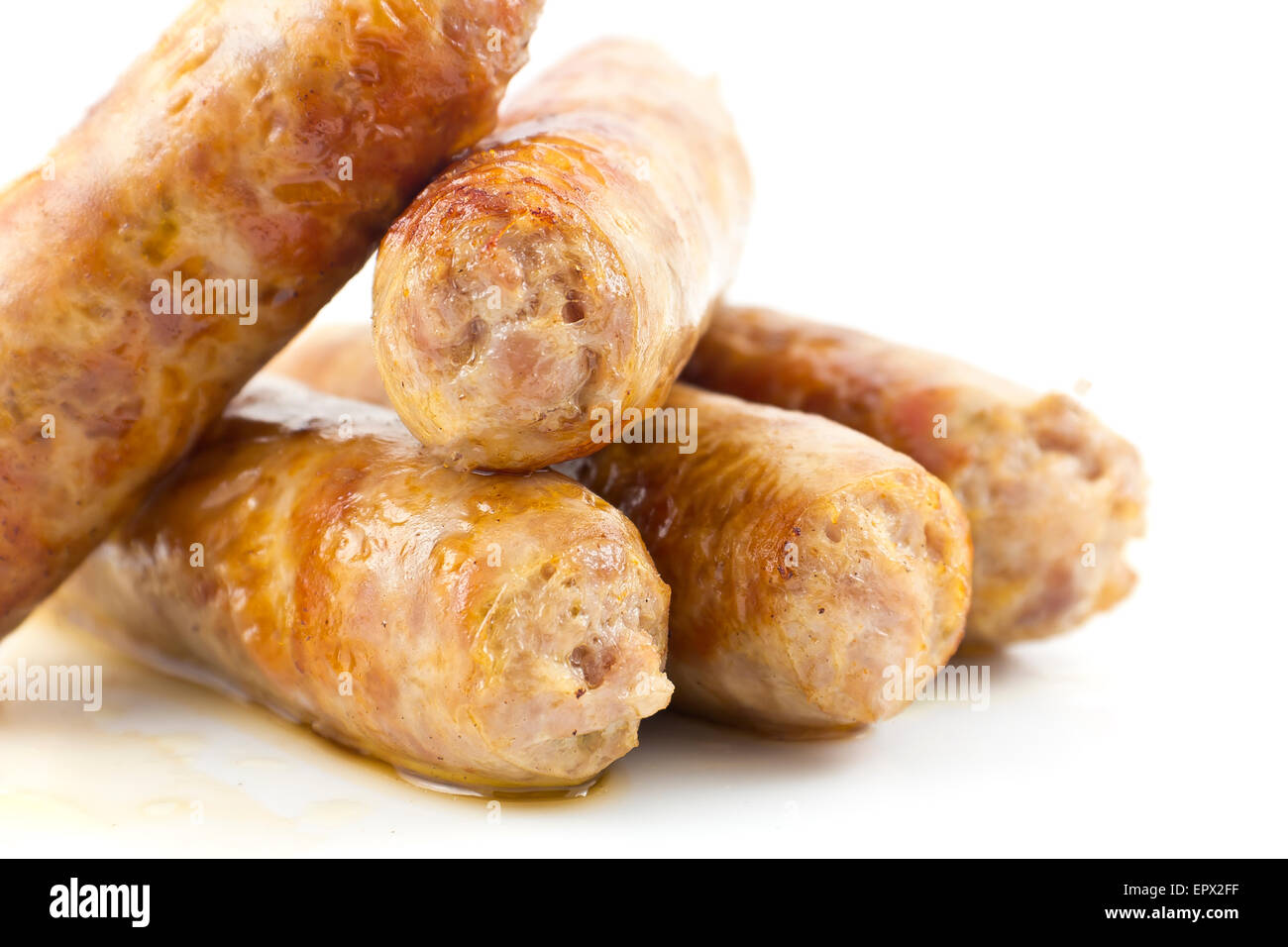 Cooked fried Italian sausage links isolated on white Stock Photo