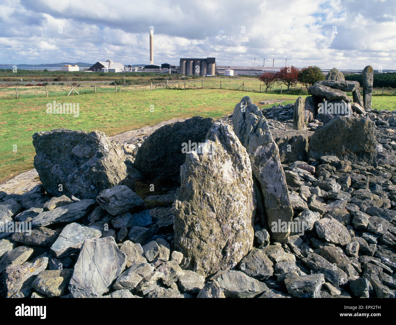 Trefignath Neolithic tomb looking eastwards towards Anglesey Aluminium factory, Holyhead, Anglesey, North Wales Stock Photo