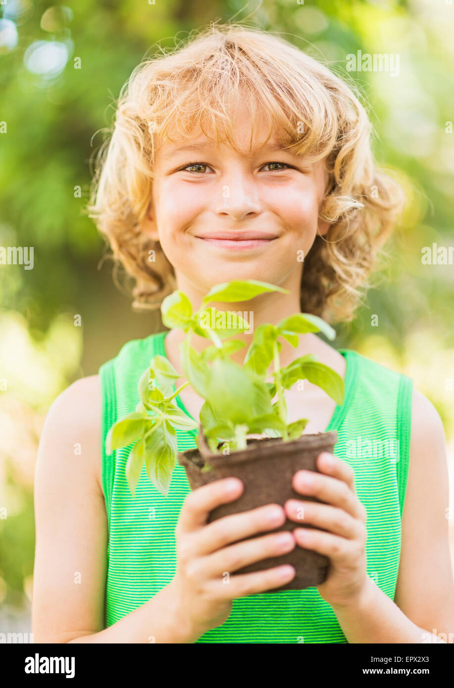Portrait of boy (8-9) holding potted plant Stock Photo - Alamy