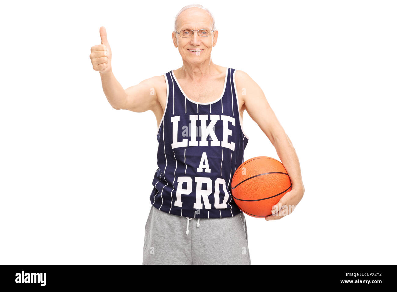 Studio shot of a cheerful senior holding a basketball and giving a thumb up isolated on white background Stock Photo