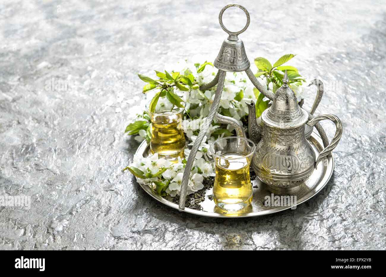 Tea glasses and pot. Oriental holidays decoration. Silver Tableware