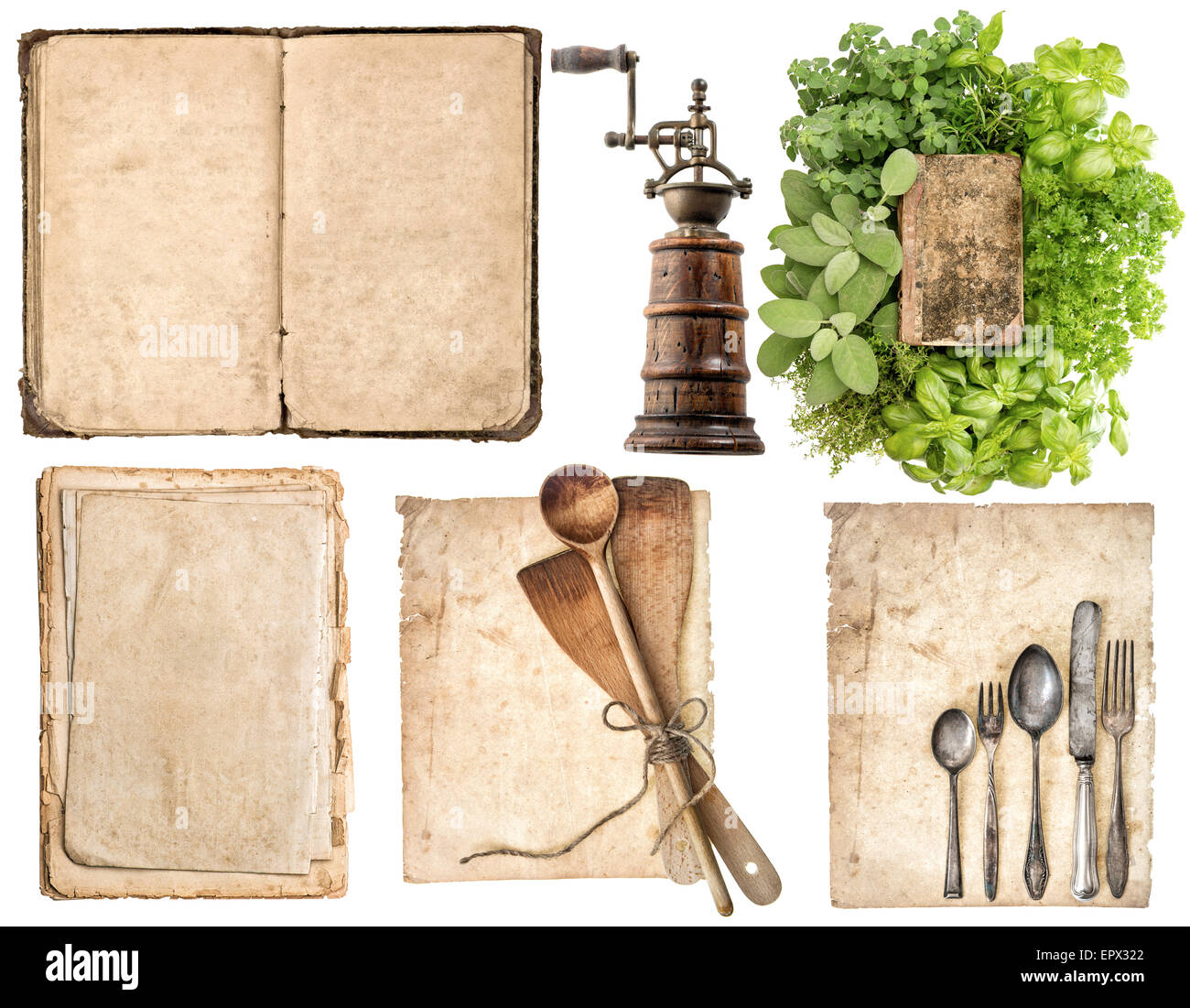 Antique wooden kitchen utensils, old cookbook, used paper pages and herbs isolated on white background. Stock Photo