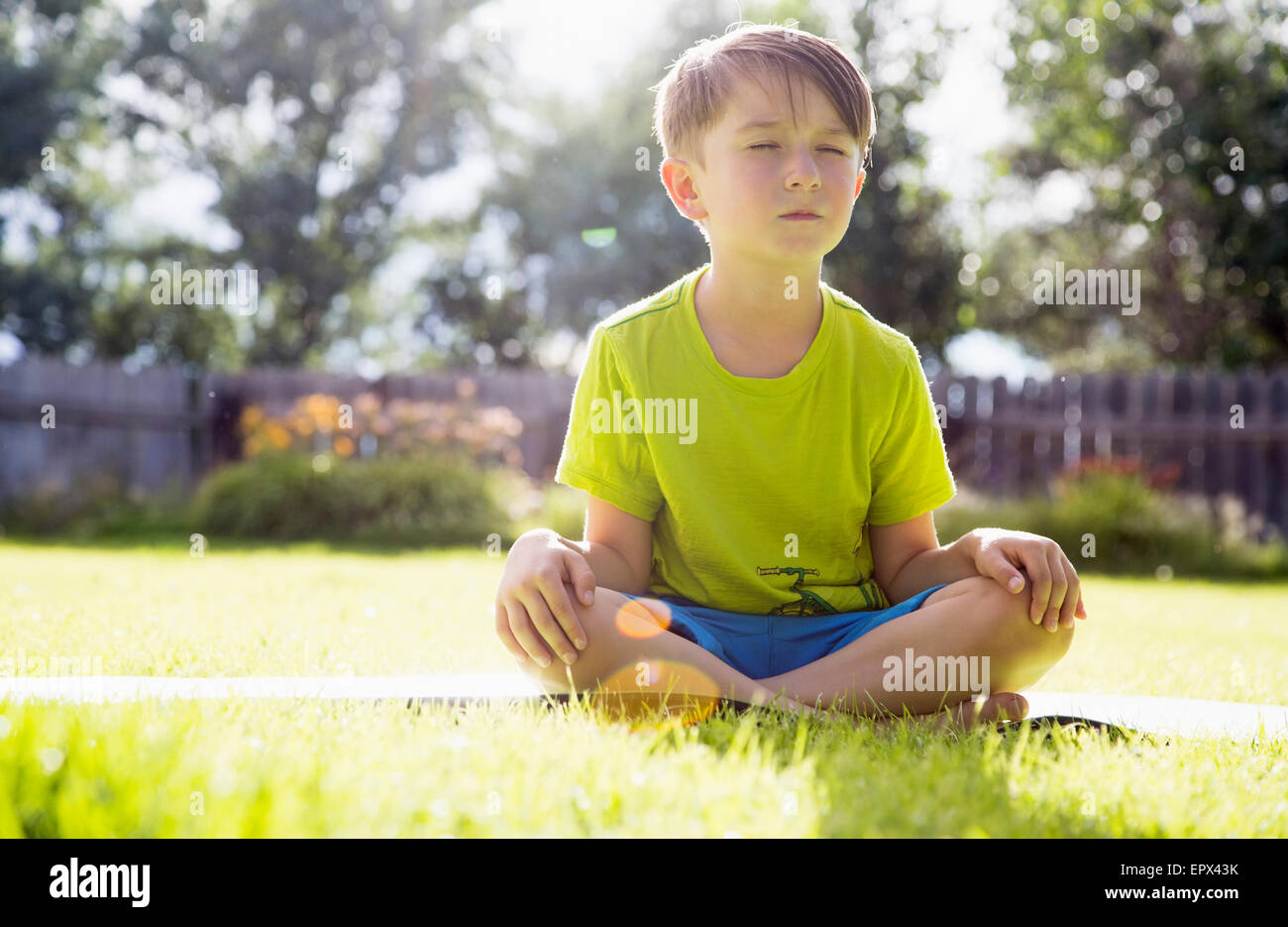 USA, Colorado, Boy (6-7) sitting in grass Stock Photo