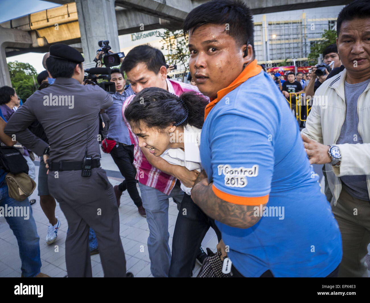 Bangkok, Bangkok, Thailand. 22nd May, 2015. Thai police scuffle with and arrest anti-coup protestors in front of the Bangkok Art and Culture Centre. The Thai military seized power in a coup on May 22, 2014. There were small protests throughout Bangkok Friday to mark the first anniversary of the coup. Police arrested protestors at several locations. The most serious protest was at Bangkok Art and Culture Centre (BACC) where about 100 protestors, mostly students, faced off against police for several hours. Credit:  ZUMA Press, Inc./Alamy Live News Stock Photo