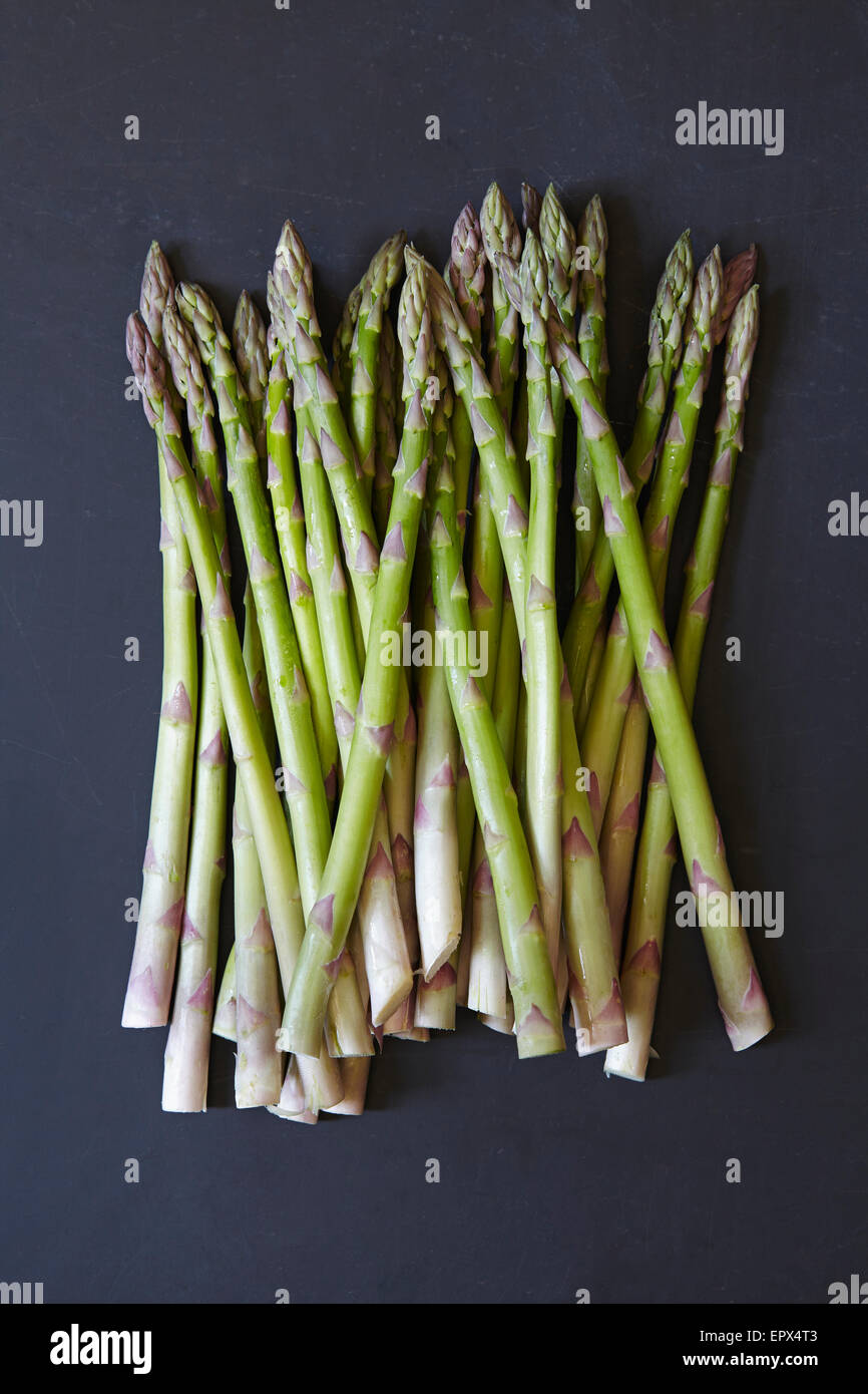Stack of asparagus on black background Stock Photo Alamy