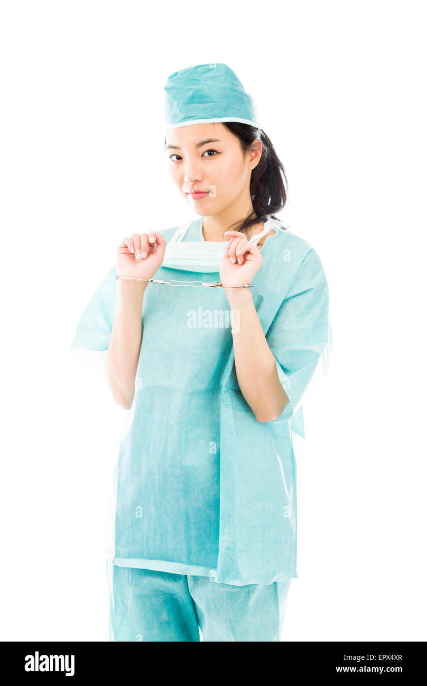 Asian female surgeon in blue uniform with handcuffed hands Stock Photo