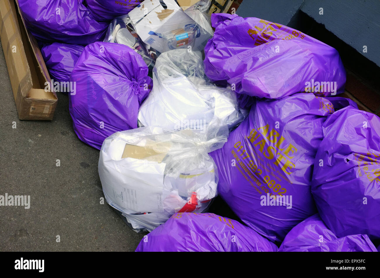 https://c8.alamy.com/comp/EPX5FC/piles-of-white-and-purple-bin-bags-in-bristol-uk-EPX5FC.jpg