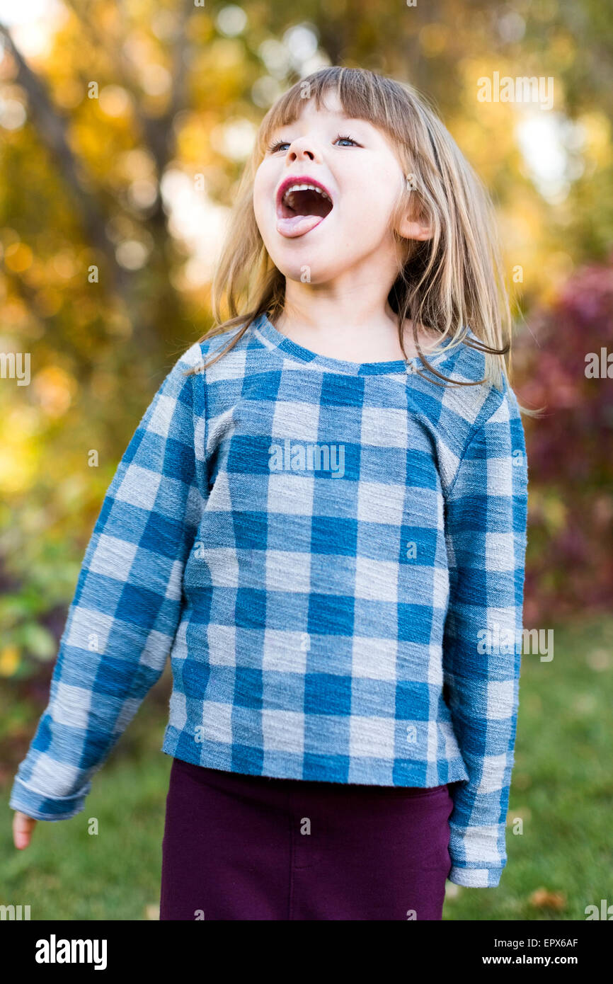 Young girl (4-5) with sticking out tongue Stock Photo