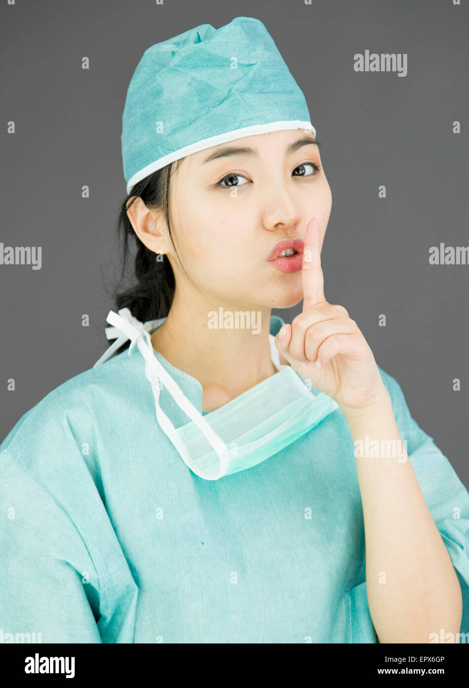 Asian female surgeon with finger on lips Stock Photo