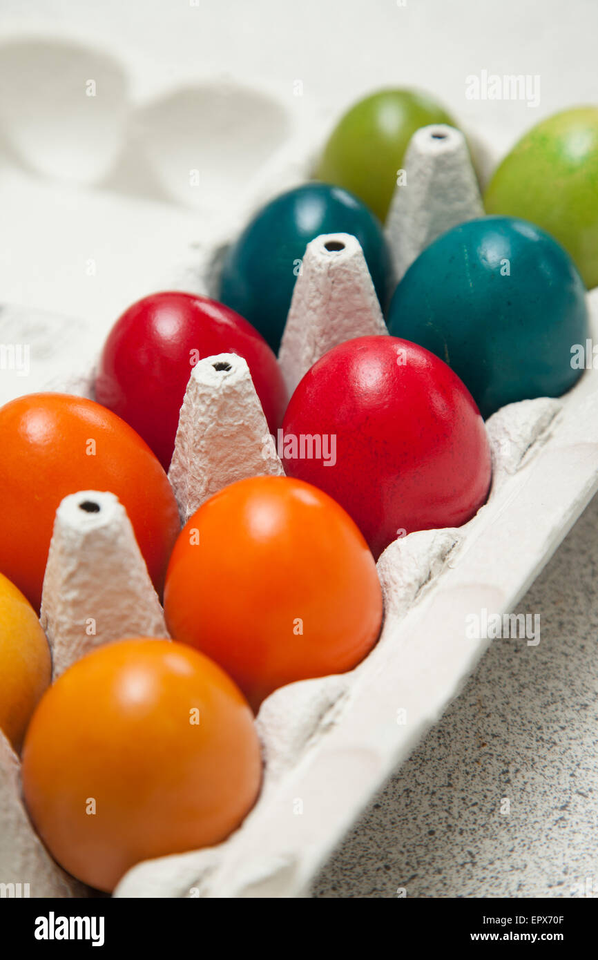 Ten eggs in an egg box which have been dyed for easter. Stock Photo