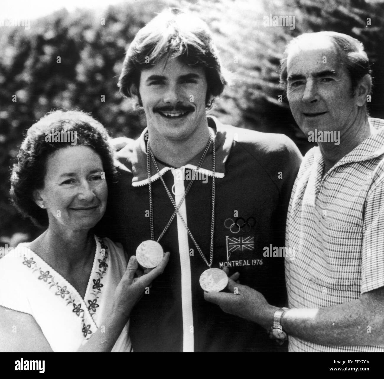 David Wilkie, Olympic Champion, 200 metre breaststroke,  Montreal Olympics, Canada, July 1976. Pictured with parents in Montreal, proudly displaying Gold medal and Silver medal he later won in 100 metre breaststroke. Stock Photo