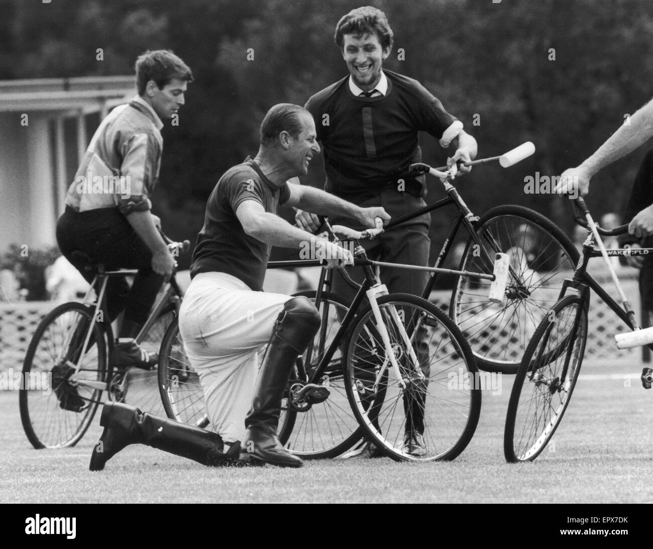 Prince Philip accepted the challenge of bicycle polo on the famous polo field at Windsor on 6th August 1967. He is pictured here after being unseated in a collision with a team mate at Windsor. The only casualty - one bent bicycle wheel. 6th August 1967. Stock Photo