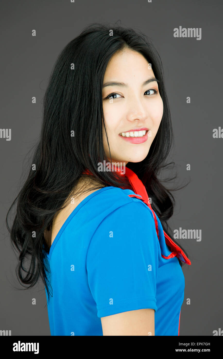 Asian young woman turning back isolated on colored background Stock Photo