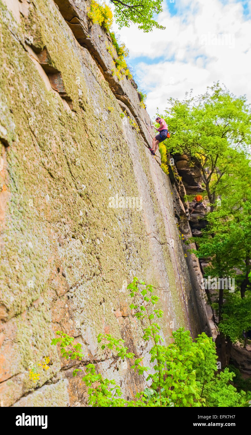 extreme sportsmen alpinists climbing up the cliff Stock Photo