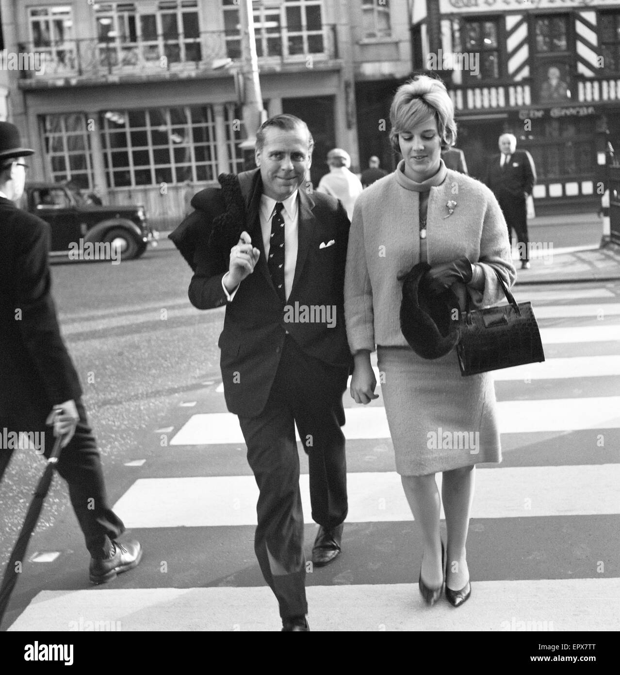 Kevin McClory, film producer, accompanied by wife and heiress Bobo Sigrist, High Court, London 22nd November 1963. Kevin McClory is suing  English author Ian Fleming for damages for alleged infringement of copyright. Stock Photo
