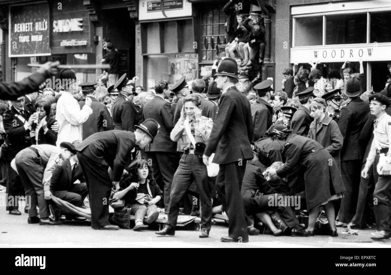 The Beatles in Liverpool, Friday 10th July 1964.  Back home for evening premiere of 'A Hard Day's Night' at the Odeon Cinema. Pictured, fans feeling faint outside Town Hall. Stock Photo