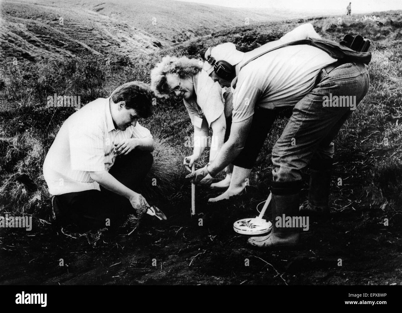 Mrs Winifred Johnson, mother of missing boy Keith Bennett, conducts one of her many searches of Saddleworth Moor, with her son Ian (left) and a volunteer with metal detector (right), August 1988.    The Moors murders were carried out by Ian Brady and Myra Stock Photo