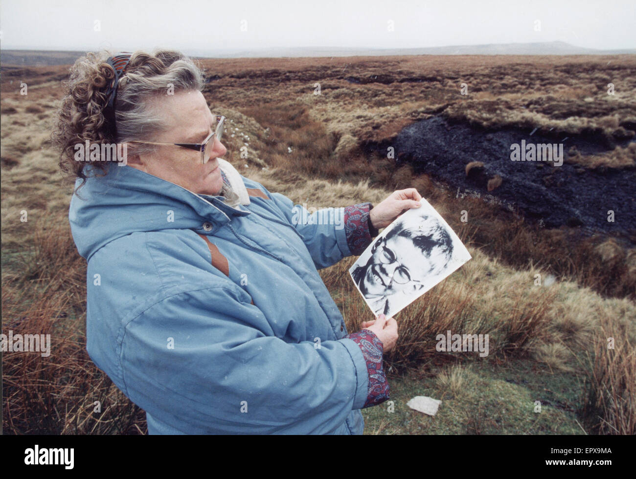 Mrs Winifred Johnson, mother of missing boy Keith Bennett, pictured on Saddleworth Moor, with a photograph of her son, 25th January 1995.   The Moors murders were carried out by Ian Brady and Myra Hindley between July 1963 and October 1965, in and around Stock Photo