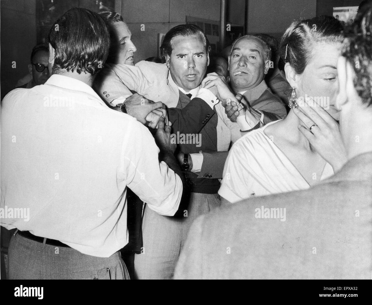 Kevin McClory, film producer, being restrained in bar room brawl with