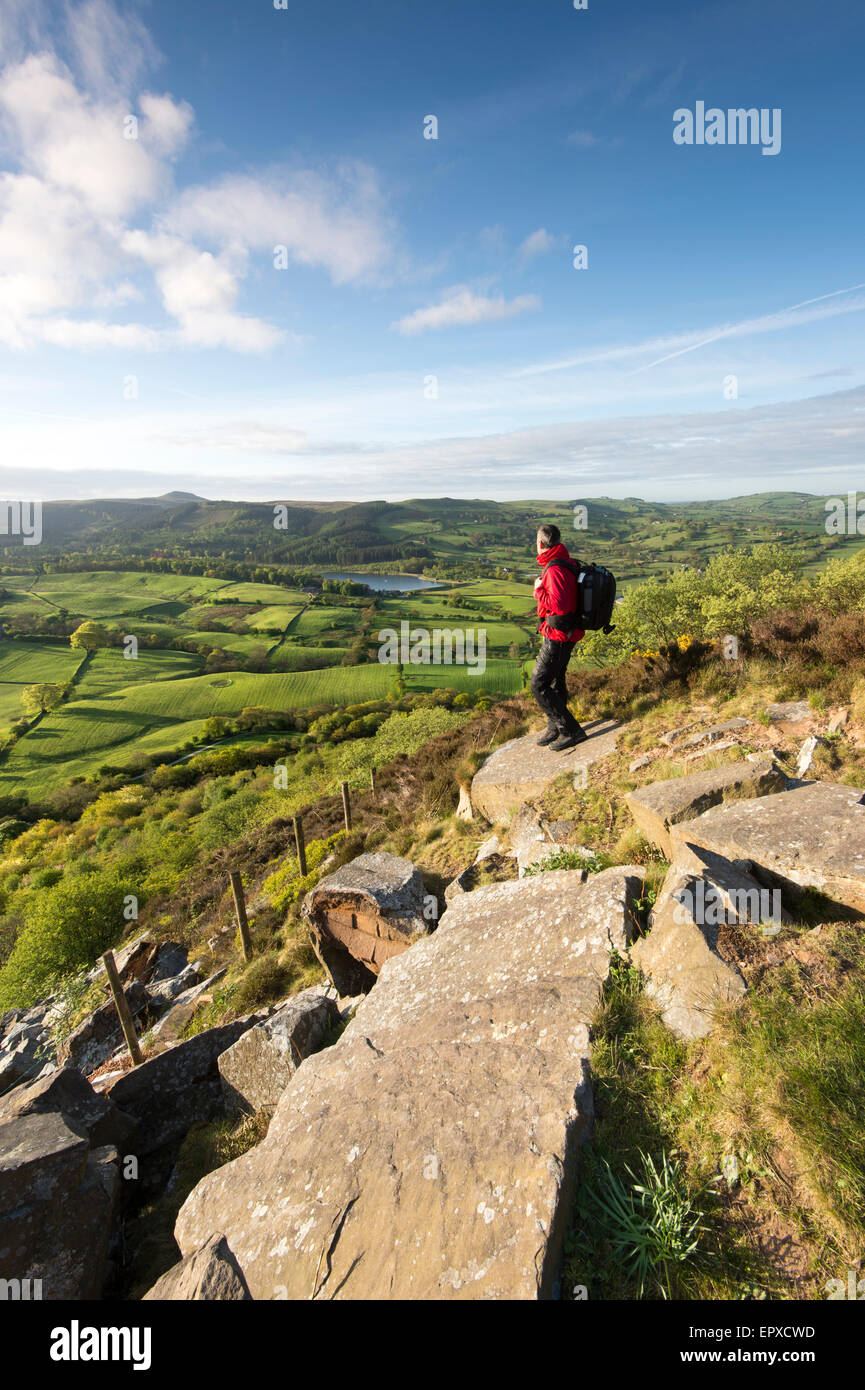 A Walker looking towards Macclesfield Forest with Ridgegate Reservoir and Shutlingsloe from Teggs Nose Country Park, Cheshi Stock Photo