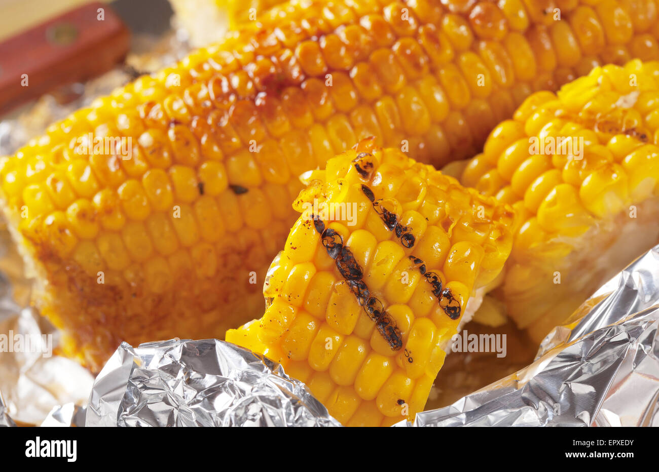 Pieces of sweet corn grilled in tin foil Stock Photo Alamy