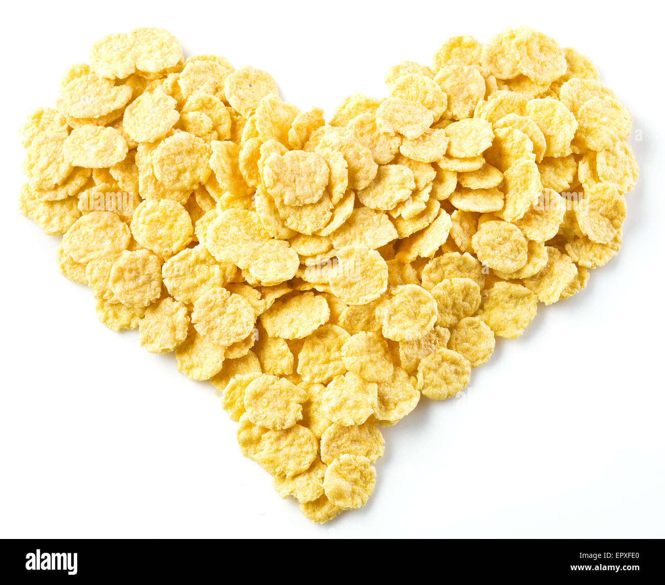 Cornflakes arranged in the shape of heart. Isolated on a white. Stock Photo