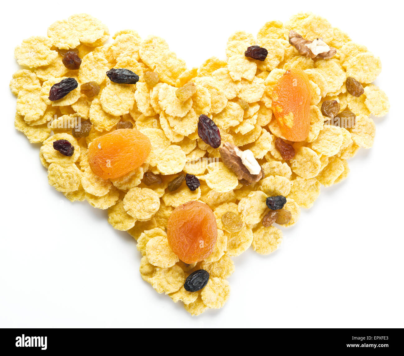Cornflakes arranged in the shape of heart. Isolated on a white. Stock Photo