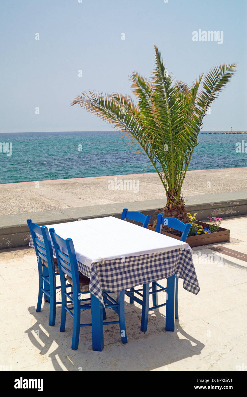 Traditional Greek table at the beach in Greece Stock Photo