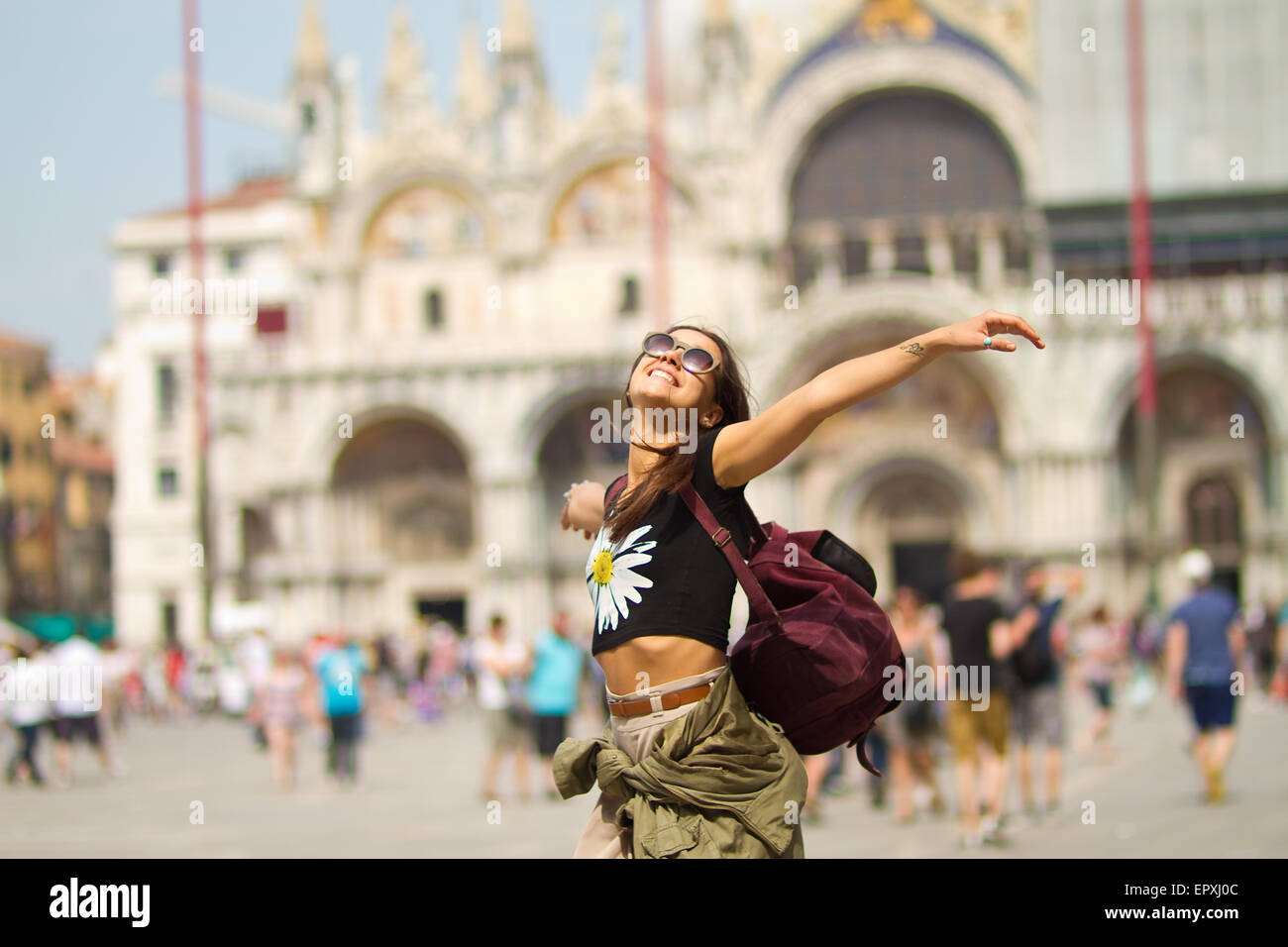 Free Spirited Girl in Venice Italy in front of Saint Mark’s Basilica Stock Photo