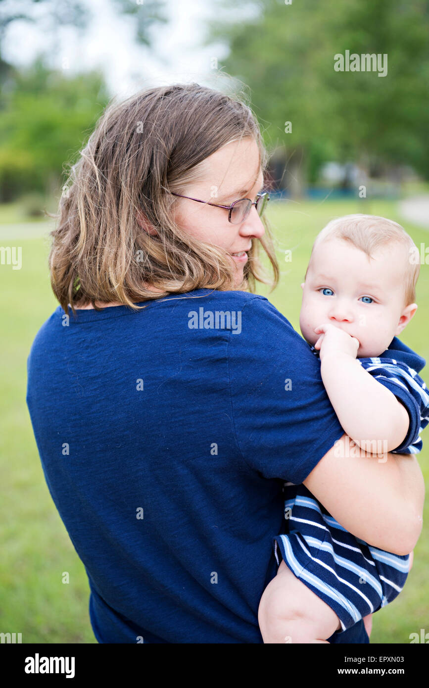 Mother looks loving at infant son Stock Photo