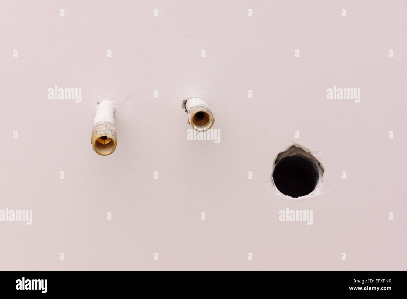 two pipes leave a wall for connection of bathroom equipment Stock Photo ...