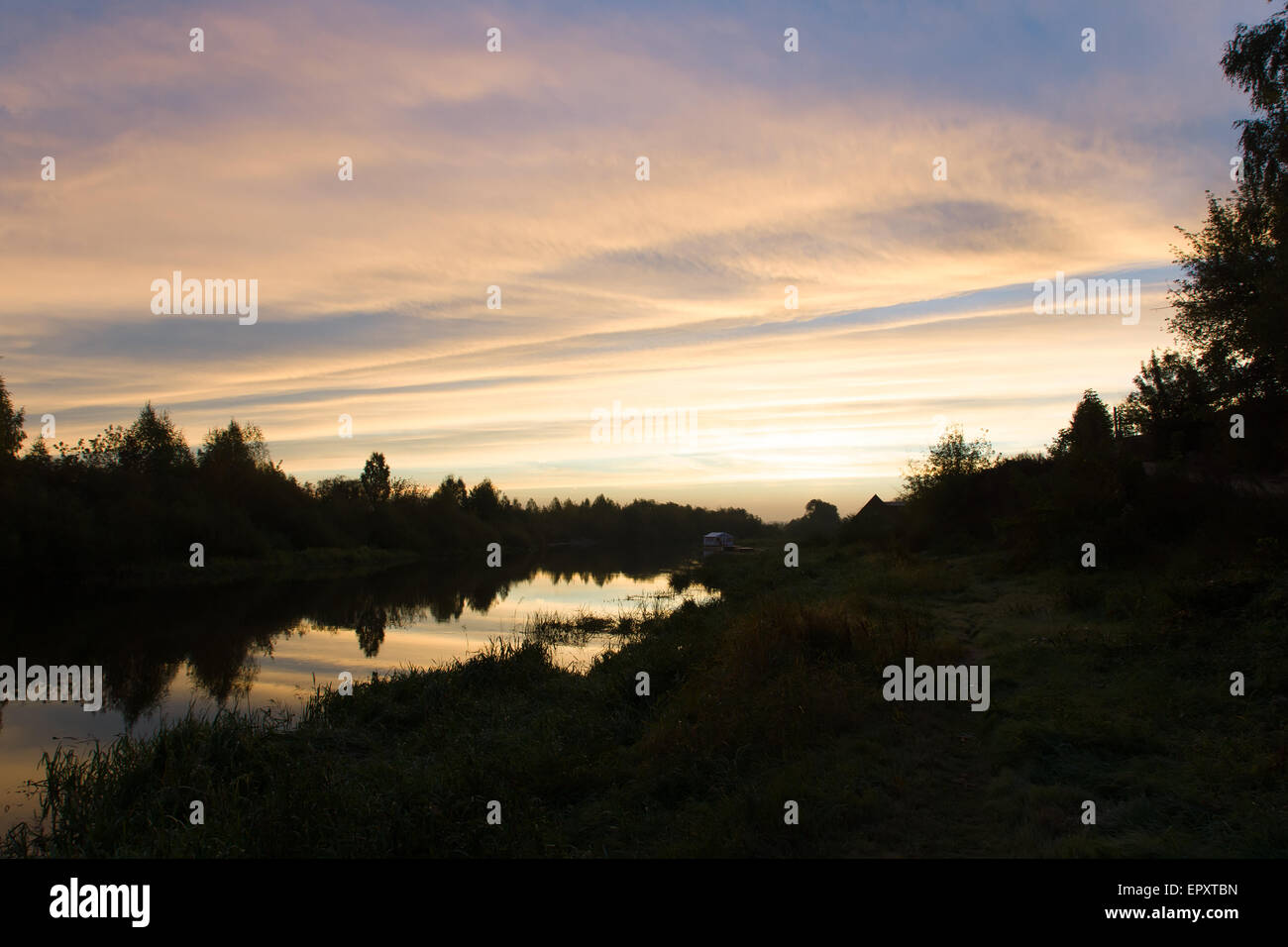 the sky is colored with different colors during sunrise over the river