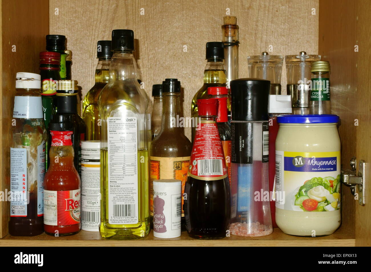 brown cupboard full of higguldy piguldy condiments Stock Photo