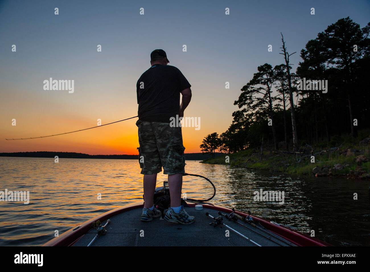 Fisherman on bow of bass boat fishing for largemouth bass at McGee