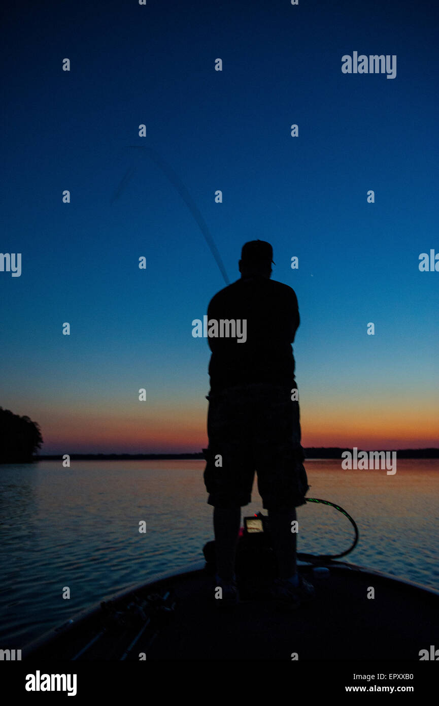 Fisherman on bow of bass boat fishing for largemouth bass at McGee