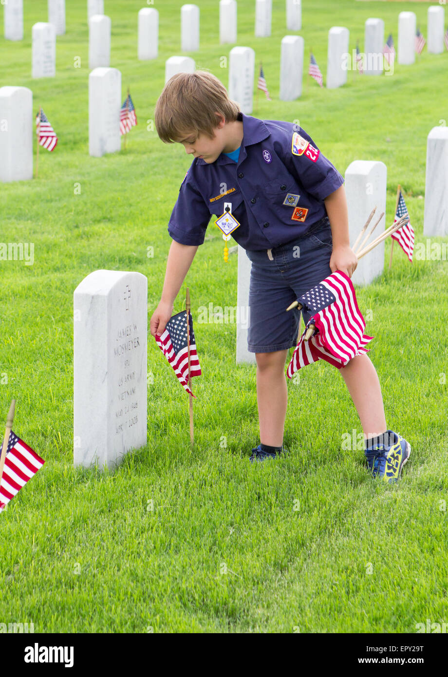 Scouting Place A cub scout places American flags at gravesites during Memorial Day ...