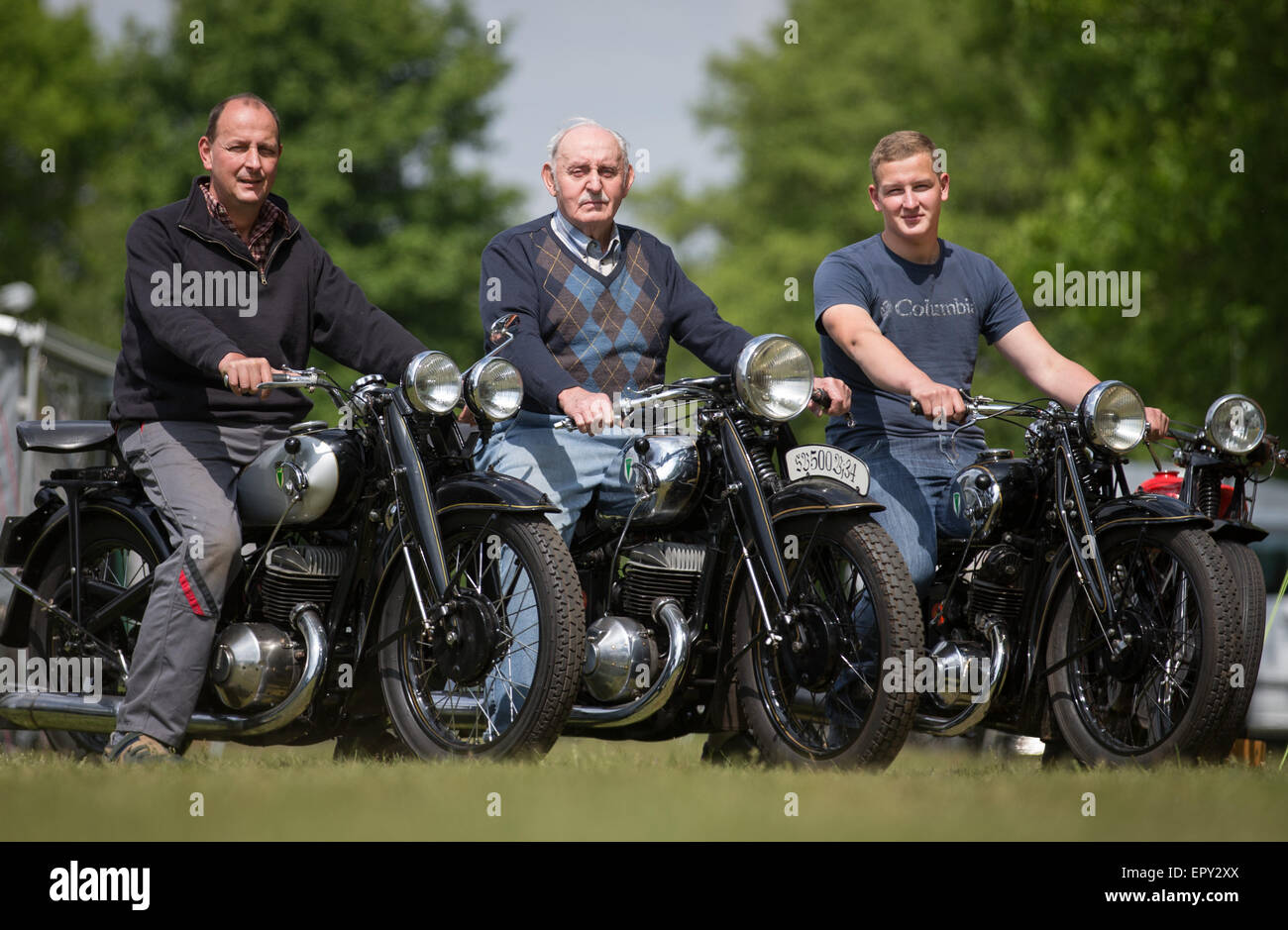 Ibbenbueren, Germany. 22nd May, 2015. Sohn Immo (52, l), Enkel Vincent (18, r) and Siegfried Quenzel (81, M) on their motorbikes in Ibbenbueren, Germany, 22 May 2015. Around 300 classic motirbikes will take part in the 35th international Ibbenbueren Classic Motorbike Rally (35. Internationaler Ibbenbuerener Motorrad-Veteranenrallye). PHOTO: FRISO GENTSCH/dpa/Alamy Live News Stock Photo