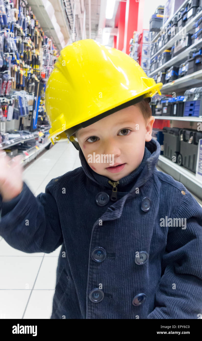 Boy pretending to be an engineer and shopping in a mechanical shop Stock Photo