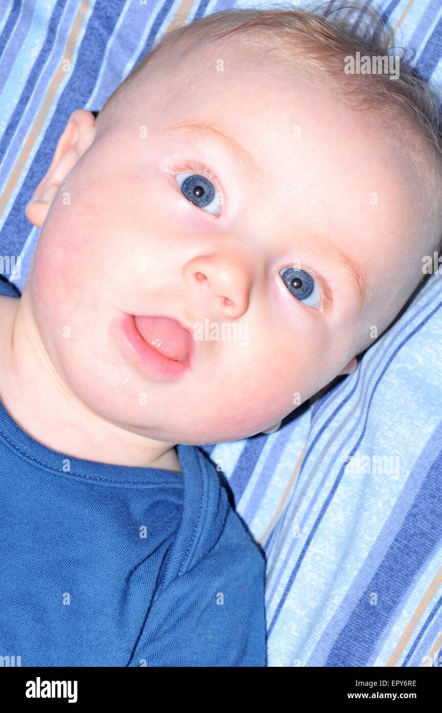 Portrait of a blueeyed baby smiling Stock Photo Alamy