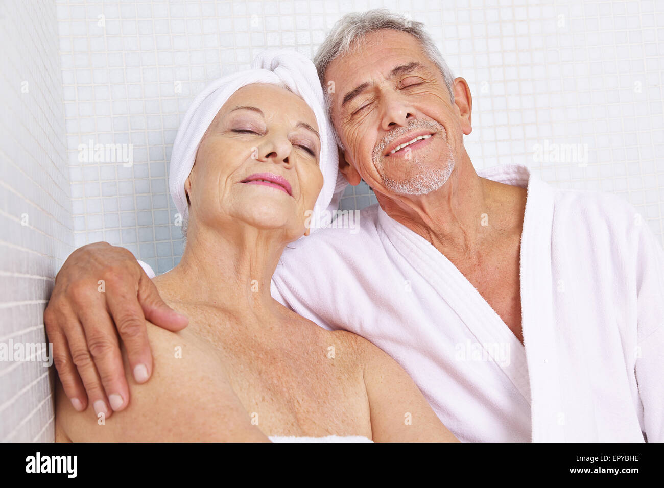 Happy senior couple sitting in relaxation room after sauna session in spa Stock Photo