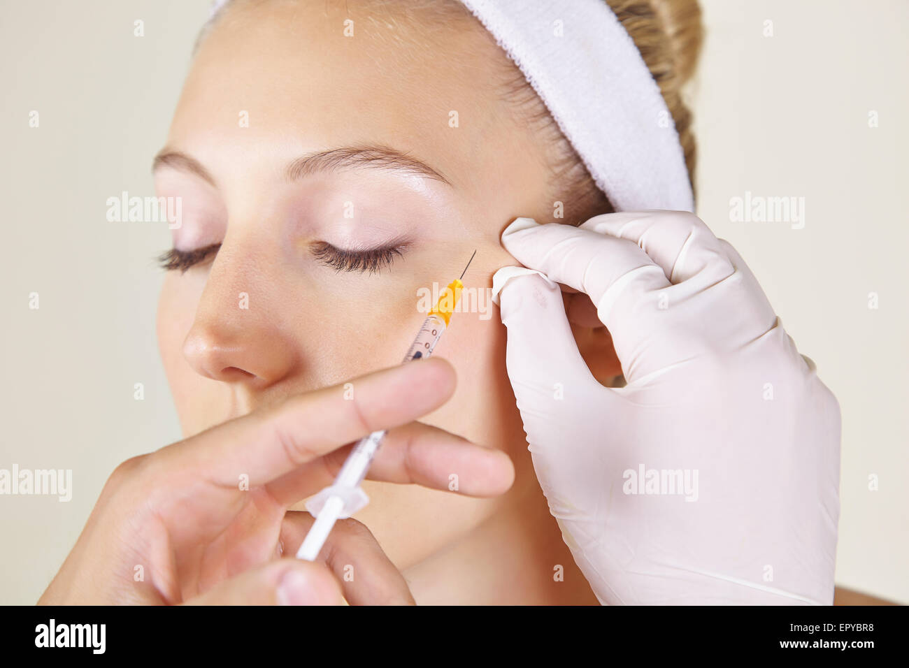 Woman in beauty clinic getting wrinkles treatment near her ayes ageinst crow's feet Stock Photo