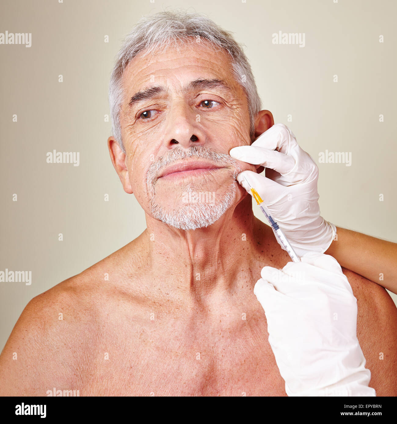 Old man getting wrinkle treatment with hyaluronic acid in beauty parlor Stock Photo