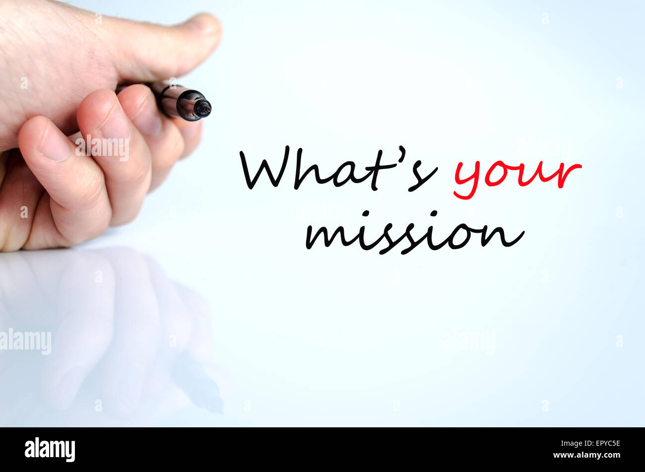 Pen in the hand isolated over white background What's your mission concept Stock Photo