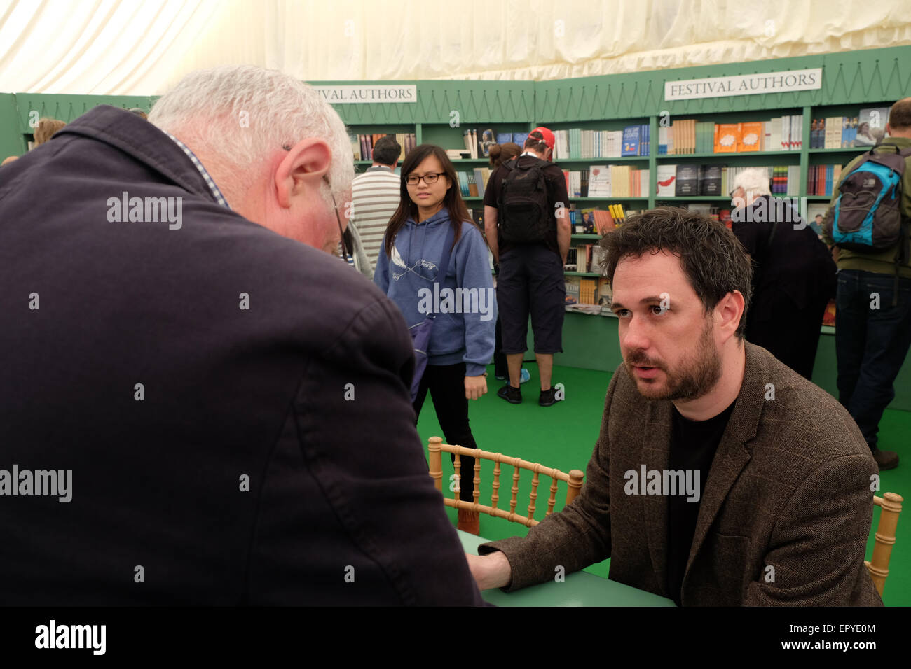 Hay Festival, Powys, Wales - May 2015 - Author Peter Moore signs copies of his latest book The Weather Experiment for fans in the Festival bookshop. Stock Photo